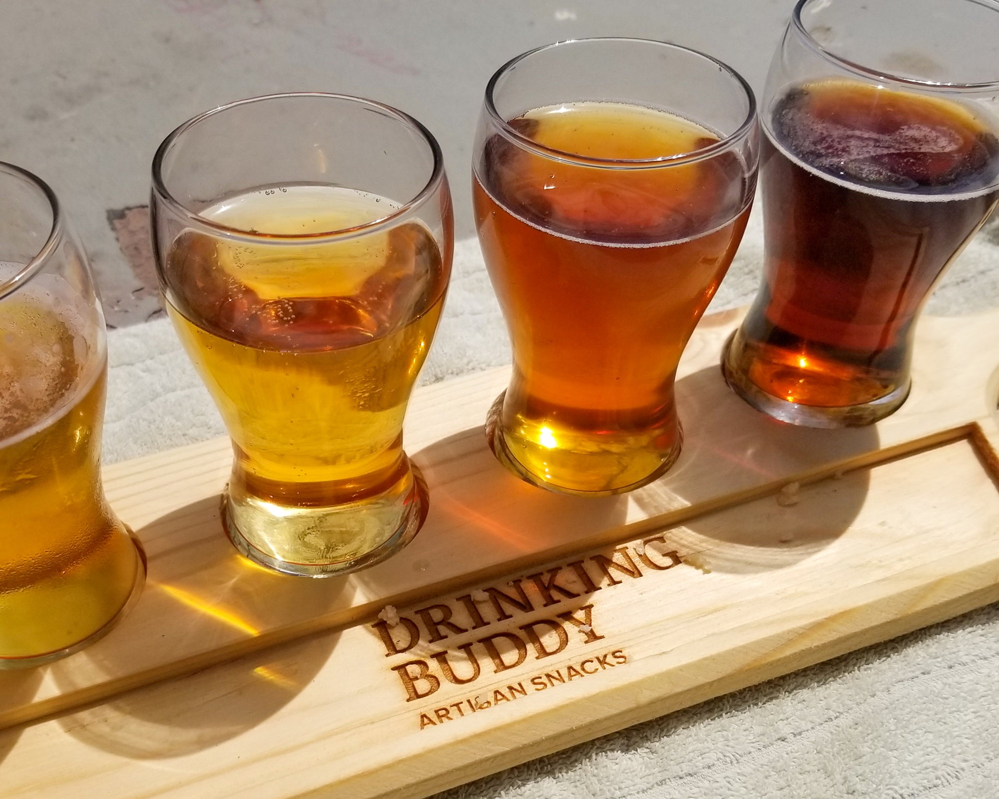 Hand-carved flight tray with Drinking Buddy logo and snack tray with tasty craft beer